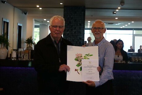John Cowie receiving award from NZPCN president John Barkla. Photo: Taylor Davies-Colley